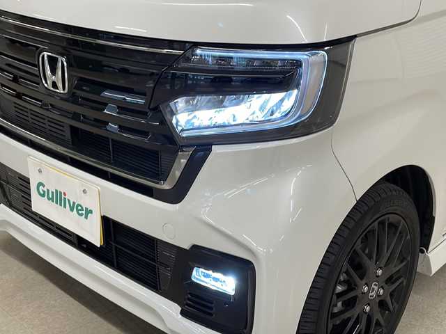 ホンダ Ｎ ＢＯＸ カスタム L スタイル+ブラック 熊本県 2023(令5)年 1.2万km プラチナホワイトパール 社外SDナビ（BT、DVD、CD、ラジオ、フルセグ）/ETC/バックカメラ/ドライブレコーダー/クルーズコントロール/両側パワースライドドア/シートヒーター/カスタムLターボ用純正ブラック15インチAW/オートハイビーム/オートライト/・LEDヘッドライト/・フォグランプ/レーンキープアシスト/横滑り防止/衝突被害軽減ブレーキ/プッシュスタート/スマートキー/・スペアキー