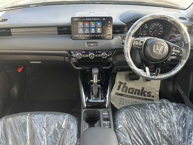 ホンダ ヴェゼル ハイブリッド e:HEV Z 三重県 2025(令7)年 0.1千km クリスタルブラックパール 登録済未使用車/純正ナビ/アップルカープレイ/アンドロイドオート/BSM/バックカメラ/追従クルーズコントロール/シートヒーター/電動リアゲート/純正ビルトインETC2.0/ワイヤレス充電/ステアリングヒーター/ステアリングスイッチ/レーンキープアシスト/衝突軽減ブレーキ/電子パーキング/LEDヘッドライト/禁煙車
