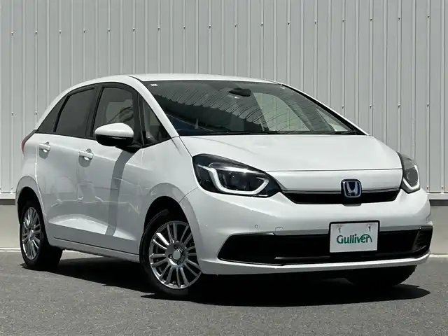 ホンダ フィット e:HEVホーム 群馬県 2023(令5)年 3.8万km プラチナホワイトパール ワンオーナー/純正SDナビ（）/ホンダセンシング/・パーキングサポートブレーキ/・急アクセル抑制機能/・ブラインドスポットインフォメーション/・トラフィックジャムアシスト/・衝突軽減ブレーキ/・先行車発進お知らせ機能/・歩行者事故低減ステアリング/・路外逸脱抑制機能/・標識認識機能/・アダプティブクルーズコントロール/・オートハイビーム/ライトレベライザー/電動格納ミラー/革巻きステアリング