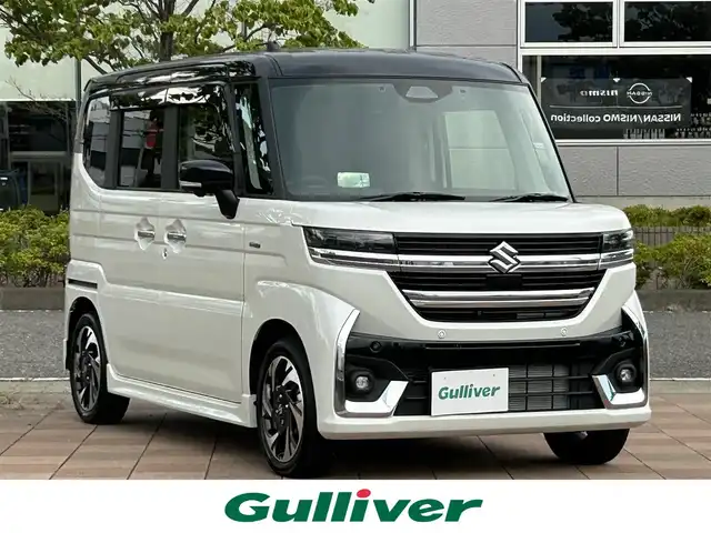 スズキ スペーシア カスタム HYBRID XS ターボ 福島県 2025(令7)年 0.1千km ピュアホワイトパール/ブラック2トーン スズキセーフティサポート/デュアルセンサーブレーキサポートII/アダプティブクルーズコントロール（ACC）/車線維持支援機能/車線逸脱抑制機能/車線逸脱警報機能/ふらつき警報機能/標識認識機能/ハイビームアシスト/発進お知らせ機能/ヘッドアップディスプレイ/誤発進抑制機能/後方誤発進抑制機能/スズキコネクト対応通信機装着車/純正ナビゲーション/【CD/DVD/USB/HDMI/BT/TV】/全方位モニター/ドライブレコーダー１２型デジタルミラー/型番：DVR-DM1246A-IC/フリップダウンモニター/ビルトインETC/両側電動スライドドア/前席シートヒーター/ステアリングヒーター/ステアリングリモコン/パドルシフト/シートバックテーブル/リアサーキュレーター/後席マルチユースフラップ/リアドアロールサンシェード/LEDオートライト/LEDフォグランプ/純正フロアマット/純正ドアバイザー