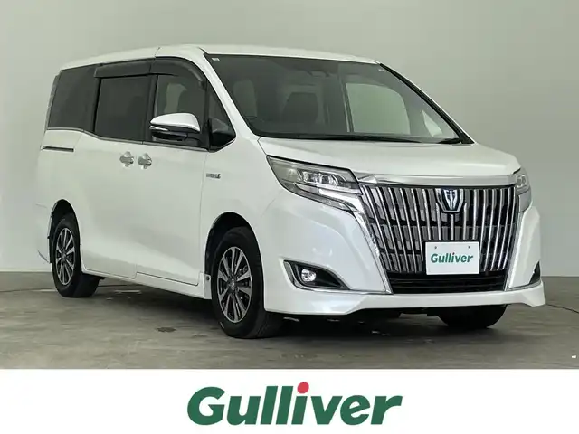 トヨタ エスクァイア ハイブリッド Gi プレミアムパッケージ 千葉県 2018(平30)年 5.8万km ホワイトパールクリスタルシャイン 禁煙車/両側電動ドア/トヨタセーフティセンス/・レーンディパーチャーアラート/・先行車発進システム/・クルーズコントロール/・クリアランスソナー/純正9インチメモリナビ/・型番：NSZT-Y66T/・CD/DVD/Bluetooth/フルセグTV/・バックカメラ/・ビルトインETC/社外フリップダウンモニター/ハーフレザーシート/・DNシートヒーター/革巻きステアリング/・ステアリングスイッチ/・ステアリングヒーター/左右独立エアコン/純正フロアマット/純正15インチAW/電動格納ウインカーミラー/オートライト/・オートマチックハイビーム/・LEDヘッドライト/・LEDフォグランプ