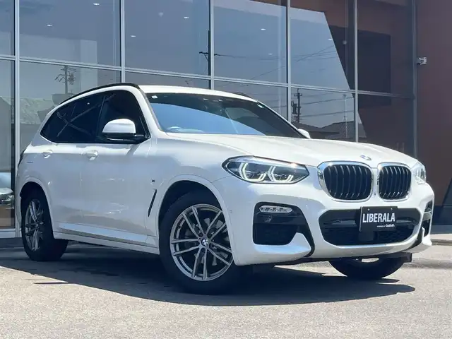 ＢＭＷ Ｘ３ xDrive20d Mスポーツ 岐阜県 2019(令1)年 2.7万km アルピンホワイトⅢ ドライビングアシストプラス/ACCアクティブクルーズ・コントロール（ストップ&ゴー機能付） /ステアリング&レーンコントロールアシスト /レーンディパーチャーウォーニング（車線逸脱警告システム） /レーン・チェンジウォーニング /アクティブ・サイドコリジョン・プロテクション /前車接近警告機能 /衝突回避被害軽減ブレーキ /事故回避アシスト /後車衝突警告機能 /クロストラフィックウォーニング（フロント&リヤ）　/パーキングアシストプラス/パーク・ディスタンス・コントロール （フロント&リヤ、ビジュアル表示機能付） /パーキング・アシスト（並列・縦列） /トップ・ビュー ー サイド・ビューカメラ ー リヤビュー・カメラ（予想進路表示機能付）　/地デジＴＶ　/ヘッドアップディスプレイ ヒートシーター /パワーシート　/純正ナビ　/電動リアゲート
