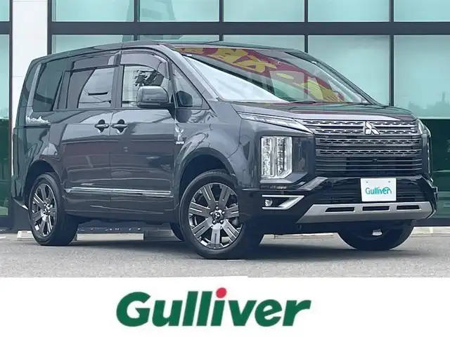 三菱 デリカＤ：５ ジャスパー 和歌山県 2023(令5)年 1.8万km グラファイトグレーメタリック/ブラックマイカ 純正10.14インチナビ/全方位カメラ/BT/CD/DVD/衝突軽減ブレーキ/レーンキープアシスト/レーダークルコン/ブラインドスポットモニター/オートライト/ETC/ドラレコ/両側パワスラ/シートヒーター/ステアリングヒーター/ステアリングリモコン/パドルシフト/パワーシート/オートホールド/純正18インチアルミ/レザー調シートカバー