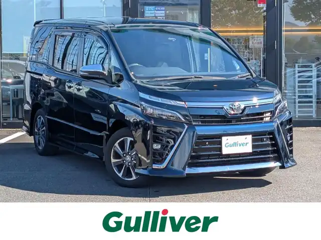 トヨタ ヴォクシー ZS 煌Ⅲ 福井県 2020(令2)年 1.5万km ブラッキッシュアゲハガラスフレーク 純正SDナビ/AM/FM/ワンセグ/BT/CD/AUX/バックカメラ/両側パワースライドドア/トヨタセーフティセンス/クルーズコントロール/前後コーナーセンサー/レーンキープアシスト/横滑り防止装置/盗難防止装置/アイドリングストップ/ビルトインETC/ハーフレザー調シート/本革巻きステアリング/ダブル＋サイドエアバッグ/カーテンエアバッグ/純正フロアマット/サンシェード/純正16インチAW/LEDヘッドライト/Fフォグ/スマートキー