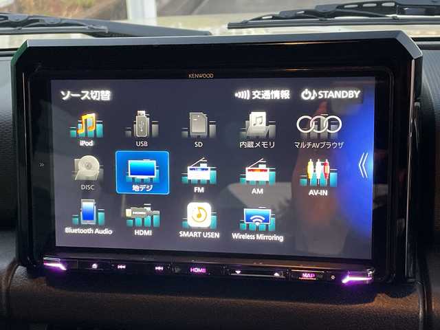 スズキ ジムニー ノマド FC 茨城県 2025(令7)年 0.3万km ベージュ ワンオーナー/セーフティーサポート/9型KEWOODナビ/ビルトインETC/バックカメラ/Bluetooth/フルセグTV/４WD/クリアランスソナー/アイドリングストップ/レーダークルーズコントロール/HDMI/シートヒーター/フロアマット/背面タイヤ/横滑り防止装置/レーンキープアシスト/オートライト/LEDヘッドライト/コーナーセンサー後方/衝突軽減システム/社外テール（純正テール積み込み）