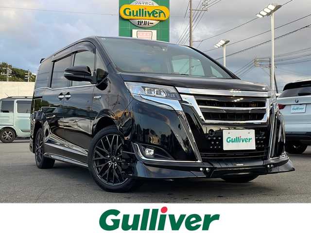 トヨタ エスクァイア ハイブリッド Gi プレミアムパッケージ 山口県 2020(令2)年 7.5万km ブラック Toyota Safety Sense C/(衝突回避支援/レーンディパーチャーアラート/オートマチックハイビーム)/フロントエアロ（TRD　SPORTIRO）/社外１１インチメモリナビ(アルパイン　EX11Z-EQ)/（AM/FM/CD/DVD/BT/フルセグ）/バックカメラ/両側電動スライドドア/クルーズコントロール/LEDオートライト/ハーフレザーシート/シートヒーター/１７インチアルミホイール/ドライブレコーダー　（AG421-DRC）/スマートキー/ビルトインETC