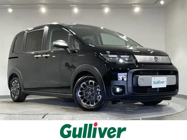 ホンダ フリード ハイブリット e:HEV クロスター 愛知県 2025(令7)年 0.1千km クリスタルブラックパール 登録済未使用車　/純正９インチナビ　/(FM/AM/フルセグTV/AppleCarPlay/AndroidAuto/Bluetooth)/ホンダセンシング　/　　-衝突軽減ブレーキ　/　　-誤発進抑制機能/　　-路線逸脱抑制機能/　　-アダプティブクルーズコントロール/　　-先行車発進お知らせ機能/　　-標識認識機能/　　-オートハイビーム/両側パワースライドドア　/シートヒーター　/ＬＥＤヘッドライト　/LEDフォグランプ/バックカメラ　/コーナーセンサー　/ブラインドスポットモニター　/ＵＳＢ接続　/アクセサリーソケット/ISOFIX/プッシュスタート/　　-スマートキー/電動パーキングブレーキ