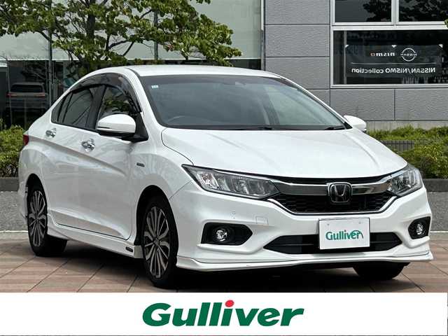 ホンダ グレイス ハイブリッド EX ホンダセンシング 福島県 2017(平29)年 4.7万km ホワイトオーキッドパール 純正ナビゲーション/型番：VXM-185VFi/【CD/DVD/SD/USB/BT/TV】/レザーシート/ホンダセンシング/衝突軽減ブレーキ〈CMBS〉/誤発進抑制機能/歩行者事故低減ステアリング/路外逸脱抑制機能/アダプティブクルーズコントロール〈ACC〉/車線維持支援システム〈LKAS〉/オートハイビーム/先行車発進お知らせ機能/標識認識機能/バックカメラ/ビルトインETC/ドライブレコーダー/パドルシフト/ステアリングリモコン/Moduloエアロ/LEDオートライト/LEDフォグランプ/純正フロアマット/ドアバイザー