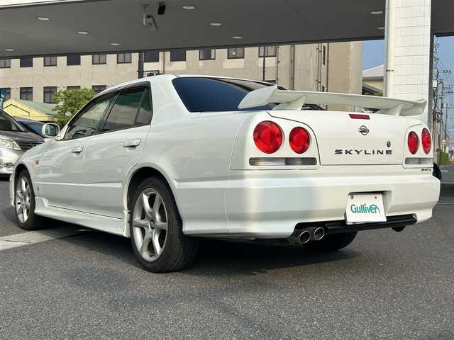 日産 スカイライン 25GT ターボ 岡山県 1998(平10)年 9.2万km ホワイトパール 登録時走行距離91445km/社外SDナビ/(AM/FM/TV/DISC/BT)/ETC/S+Rエアロ/純正17インチアルミホイール/電動格納ミラー/リモコンキー/MTモード付AT/パワーステアリング/パワーウィンドウ/キセノンヘッドライト/純正フロアマット/保証書/記録簿/取扱説明書