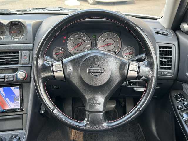日産 スカイライン 25GT ターボ 岡山県 1998(平10)年 9.2万km ホワイトパール 登録時走行距離91445km/社外SDナビ/(AM/FM/TV/DISC/BT)/ETC/S+Rエアロ/純正17インチアルミホイール/電動格納ミラー/リモコンキー/MTモード付AT/パワーステアリング/パワーウィンドウ/キセノンヘッドライト/純正フロアマット/保証書/記録簿/取扱説明書