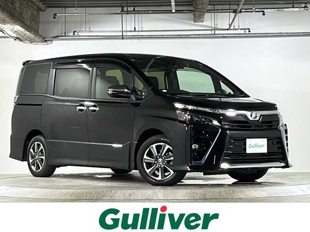 トヨタ ヴォクシー ZS 煌Ⅱ 広島県 2019(令1)年 5.1万km ブラック 純正SDナビ（NSZT-Y68T）/（FM/AM/CD/DVD/BT）/フルセグテレビ/バックカメラ/ETC/ドライブレコーダー/フリップダウンモニター/プッシュスタート/クルーズコントロール/アイドリングストップ/横滑り防止装置/衝突被害軽減システム/MTモード付AT/両側パワースライドドア/フロアマット/USB入力端子/純正LEDヘッドライト/純正フォグランプ/オートライト/オートマチックハイビーム/コーナーセンサー/純正１６インチアルミホイール/電動格納ドアミラー/純正ドアバイザー