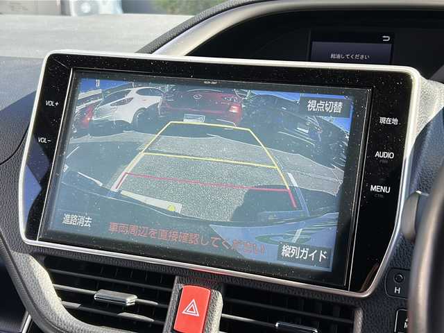 トヨタ ヴォクシー ハイブリッド ZS 煌 広島県 2018(平30)年 6.4万km ブラッキッシュアゲハガラスフレーク 禁煙車/トヨタセーフティセンス/・プリクラッシュセーフティ/・先行車発進告知/・オートマチックハイビーム/・LDA/クルーズコントロール/コーナーセンサー/純正10インチナビ（NSZN-Z66T）/・CD/DVD/フルセグ/Bluetooth/SD/REC/純正フリップダウンモニター（V12T-R66C）/バックカメラ/両側パワースライドドア/革巻きステアリング/オートライト/ステアリングスイッチ/D/Nシートヒーター/LEDヘッドライト/フォグランプ/サンシェード/ビルトインETC/純正フロアマット/純正ドアバイザー/スマートキー/プッシュスタート/スペアキー/純正16インチアルミホイール