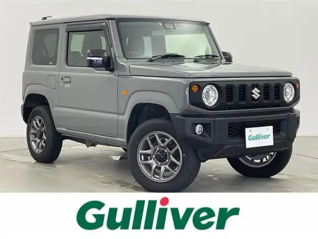 スズキ ジムニー XC 富山県 2022(令4)年 2万km ミディアムグレー 4WD/ワンオーナー/純正SDナビ（CN-RZ775W）/地図SD未着のため動作未確認/クルーズコントロール/レーンアシスト/ドライブレコーダー/前席シートヒーター/アイドリングストップ/プッシュスタート/スマートキー/ステアリングスイッチ/ダウンヒルアシストコントロール/衝突被害軽減システム/盗難防止装置/横滑り防止装置/純正16インチAW/純正ドアバイザー/LEDヘッドライト