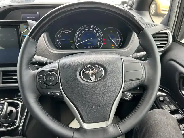 トヨタ エスクァイア ハイブリッド Gi プレミアムパッケージ ブラックテーラード 岡山県 2019(令1)年 9.6万km スパークリングブラックパールクリスタルシャイン 登録時走行距離95162km/社外10インチナビ/フルセグTV(AM.FM.CD.DVD.TV.BT)/両側パワースライドドア/バックカメラ/ETC/ドライブレコーダー/シートヒーター/クリアランスソナー/衝突軽減ブレーキ/クルーズコントロール/レーンキープアシスト/オートマチックハイビーム/アイドリングストップ/15インチ純正AW/純正フロアマット