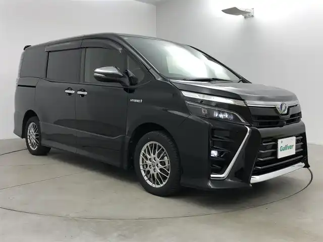 トヨタ ヴォクシー ハイブリッド ZS 煌Ⅱ 愛知県 2019(令1)年 6.6万km ブラック アルパイン11型ナビ/（Bluetooth/フルセグTV/CD/DVD/HDMI）/EX11Z/アルパイン１２．８型フリップダウンモニター/PXH12X-R/両側電動スライドドア/トヨタセーフティセンス/・プリクラッシュセーフティ/・レーンアシスト/・オートマチックハイビーム/前席シートヒーター/バック・サイド・フロントカメラ/HDMI/純正１６インチAW/205/55/R16/ドライブレコーダー/ZDR-015/純正LEDライト/クルーズコントロール/スマートキー/保証書/取扱説明書