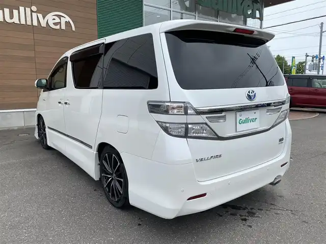 トヨタ ヴェルファイア ハイブリット ZR Gエディション 道央・札幌 2013(平25)年 9.4万km ホワイトパールクリスタルシャイン 登録時走行距離 93155km/　4　W　D　/フロントモデリスタエアロ/ローダウン/純正メーカーOPナビ/(AM/FM/CD/DVD/BT)/フルセグTV/バックカメラ/プレミアムサウンド/純正フリップダウンモニター/両側パワースライドドア/パワーバックドア/ビルトインETC/黒革シート/助手席オットマン/2列目キャプテンシート/社外ウィンカーミラー/社外フロントグリル/ウッドコンビステアリング/社外レーダー/純正サスペンション積込/社外テール積込(動作未確認)/純正AW付冬タイヤ積込/215/65R16 2023年製 7mm