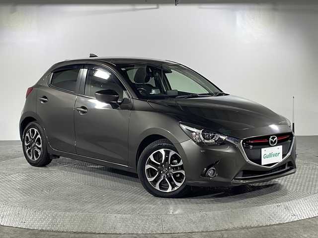 マツダ デミオ XD ツーリング 沖縄県 2016(平28)年 1.6万km チタニウムフラッシュマイカ 県外仕入れ　/禁煙車/純正ナビ/・ＣＤ／ＤＶＤ／フルセグＴＶ／Ｂｌｕｅｔｏｏｔｈ/バックカメラ/ヘッドアップディスプレイ/純正１６インチアルミ/シートヒーター/ＥＴＣ/クルーズコントロール/スペアキー/USB/保証書/取扱説明書