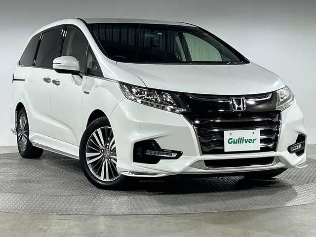 ホンダ オデッセイ ハイブリッド アブソルート・EXホンダセンジング 神奈川県 2018(平30)年 6.5万km プラチナホワイトパール 純正9型メモリーナビゲーション【VXM-187VFNi】/純正フリップダウンモニター/フルセグ　CD DVD　SDMUSICRACK　Bluetooth　iPod　USB/マルチビューカメラ/スマートパーキングアシスト/パーキングセンサーシステム/ブラインドスポットインフォメーション/ホンダセンシング/衝突軽減ブレーキ/歩行者事故低減ステアリング/アダブティブクルーズコントロール/LKAS車線維持支援システム/路外逸脱抑制機能/誤発進抑制機能/先行車発進お知らせ機能/標識認識機能/ECON/純正ビルトインETC2.0/2列目オットマン/ハーフレザーシート/前席シートヒーター/パワーシート/革巻きステアリング/自動防眩ルームミラー/社外前後ドライブレコーダー/電動パーキングブレーキ/オートブレーキホールド/プラズマクラスター付オートエアコン/プッシュスタート/スマートキー/LEDヘッド/フォグランプ/LEDアクティブコーナリングランプ/オートライト/純正17インチアルミホイール/純正サイド/リアスポイラー/スペアキー