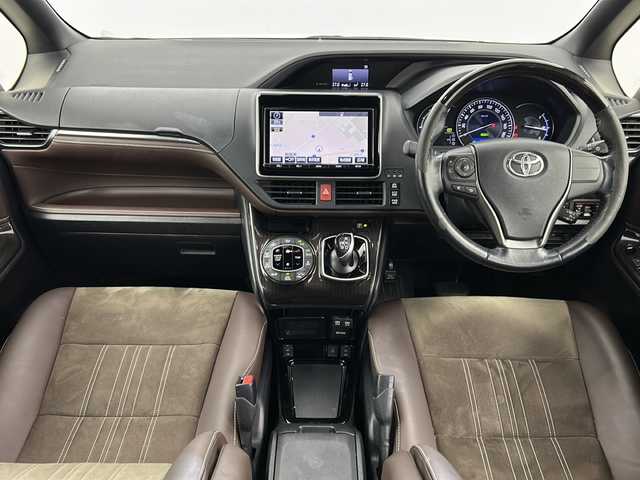 トヨタ エスクァイア ハイブリッド Gi プレミアムパッケージ 宮城県 2017(平29)年 11.8万km ホワイトパールクリスタルシャイン 禁煙車/フリップダウンモニター/トヨタセーフティセンス/・プリクラッシュセーフティ/・レーンディパーチャーアラート/・オートマチックハイビーム/・レーダークルーズコントロール/純正9インチSDナビ/・BT/AM/FM/CD/SD/フルセグTV /バックカメラ/両側パワースライドドア/前席シートヒーター/ビルトインETC/革巻きステアリング/ステアリングヒーター/プッシュスタート/スマートキー×2/LEDヘッドライト/LEDフォグランプ/社外15インチアルミホイール/積み込み純正アルミホイール付き夏タイヤ/（195/65R15）/純正フロアマット/純正ドアバイザー