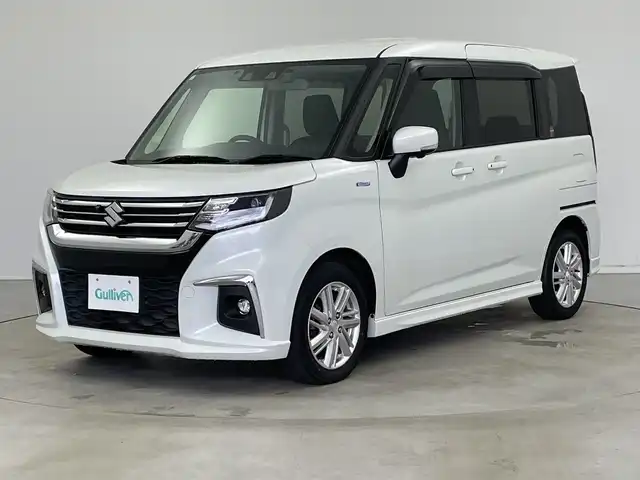 スズキ ソリオ HV MZ 新潟県 2021(令3)年 6万km ピュアホワイトP 純正メモリナビ/（BT/FM/AM/フルセグTV/DVD)/全周囲カメラ/衝突軽減ブレーキ/レーダークルーズコントロール/ステアリングスイッチ/シートヒーター/両側パワースライド/ヘッドアップディスプレイ/純正15インチアルミホイール/純正フロアマット/純正オートヘッドライト/電格ミラー/サンシェード/ETC