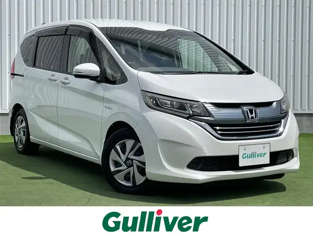 ホンダ フリード ハイブリット G ホンダセンシング 香川県 2017(平29)年 5.7万km ホワイトオーキッドパール 登録時走行距離；56574km/純正9インチナビ　（VXM-175VFNi）/・フルセグTV　CD/DVD/SD/Bluetooth/前後ドライブレコーダー/ETC/ホンダセンシング/衝突軽減ブレーキ/レーンキープアシスト/横滑り防止/アダプティブクルーズコントロール/バックカメラ/ステアリングスイッチ/両側パワースライドドア/プッシュスタート/純正フロアマット/純正15インチホイールキャップ