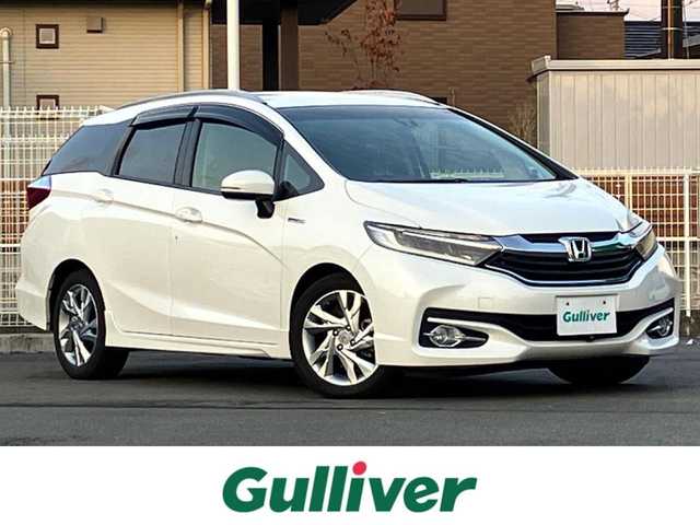 ホンダ シャトル ハイブリッド Z 静岡県 2015(平27)年 4.2万km ホワイトオーキッドパール 純正ナビ(CD/DVD/BT/フルセグ)/バックカメラ/ドライブレコーダー前後・全方位/ETC/エンジンスタートボタン/パワーステアリング/パワーウィンドウ/アイドリングストップ/パドルシフト/寒冷地仕様/保証書/取扱説明書/スマートキー/スペアキー１本/クルーズコントロール/純正フロアマット/ハーフレザーシート/D席N席シートヒーター/ルーフレール/純正アルミホイール/ABS/横滑り防止装置/オートライト/LEDヘッドライト/W+サイドエアバッグ/カーテンエアバッグ/衝突軽減システム/デジタルインナーミラー