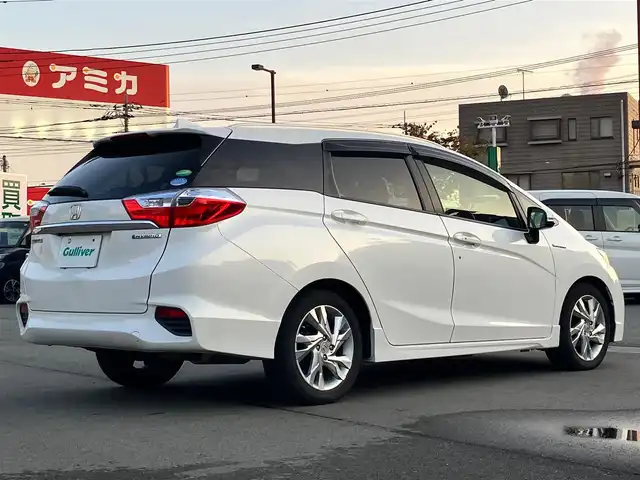 ホンダ シャトル ハイブリッド Z 静岡県 2015(平27)年 4.2万km ホワイトオーキッドパール 純正ナビ(CD/DVD/BT/フルセグ)/バックカメラ/ドライブレコーダー前後・全方位/ETC/エンジンスタートボタン/パワーステアリング/パワーウィンドウ/アイドリングストップ/パドルシフト/寒冷地仕様/保証書/取扱説明書/スマートキー/スペアキー１本/クルーズコントロール/純正フロアマット/ハーフレザーシート/D席N席シートヒーター/ルーフレール/純正アルミホイール/ABS/横滑り防止装置/オートライト/LEDヘッドライト/W+サイドエアバッグ/カーテンエアバッグ/衝突軽減システム/デジタルインナーミラー