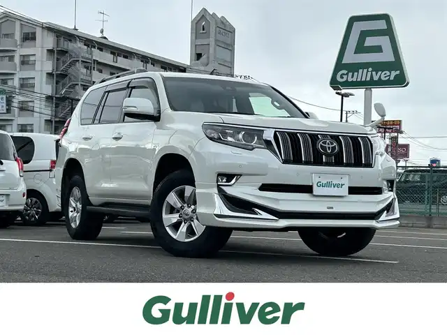 トヨタ ランドクルーザー プラド TX 大分県 2020(令2)年 5.6万km ホワイトパールクリスタルシャイン ・純正SDナビ(CD.DVD.SD.BT)/・バックカメラ/・フルセグテレビ/・モデリスタエアロ/・ルーフレール/・三列シート/・テレビナビキット/・プリクラッシュセーフティ/・レーダークルーズコントロール/・コーナーセンサー/・ETC/・オートハイビーム/・オートライト/・ステアリングリモコン/・スマートキー/・プッシュスタート/・純正フロアマット