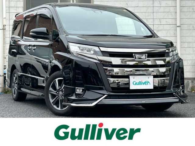 トヨタ ノア Si ダブルバイビーⅡ 福岡県 2019(平31)年 4.3万km ブラック MODELLISTAエアロ（フロント、サイド）/純正10インチメモリナビ【NSZN-Z68T】/　（FM/AM/HDMI/CD/DVD/Bluetooth/フルセグTV）/バックカメラ/純正12インチフリップダウンモニター(リモコン付)【V12T-R68C】/トヨタセーフティーセンス/・プリクラッシュセーフティー/・レーントレーシングサポート/・レーダークルーズコントロール/・レーンディパーチャーアラート/・オートマッチックハイビーム/・パーキングサポートブレーキ/・先行車発進アラーム/クリアランスソナー/横滑り防止装置/盗難防止装置/オートライト/純正16インチアルミホイール/黒ハーフレザーシート/両側パワースライドドア/ナビ連動純正ドライブレコーダー【DRT-C68A】/ビルトインETC/アイドリングストップ/ドアバイザー/プッシュスタート/純正フロアマット/ISOFIX/2.1A電源プラグ×2/スペアキー×1/保証書/取扱説明書/ナビ取扱説明書/ETC取扱説明書
