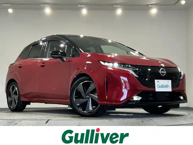 日産 オーラ G 愛知県 2023(令5)年 0.6万km ガーネットレッド/スーパーブラック 2トーン 純正９インチディスプレイナビ　/（Bluetooth/フルセグTV/CarPlay/USB/HDMI/AM/FM)/ＢＯＳＥサウンド　/プロパイロット　/ワイヤレス充電　/ＳＯＳコール　/アラウンドビューモニター　/エマージェンシーブレーキ　/ビルトインＥＴＣ２．０　/ドライブレコーダー　/デジタルインナーミラー　/ＬＥＤヘッドライト/LEDフォグランプ/ブラインドスポットモニター（BSW)/コーナーセンサー/車線逸脱警報/ハンドル支援/純正フロアマット