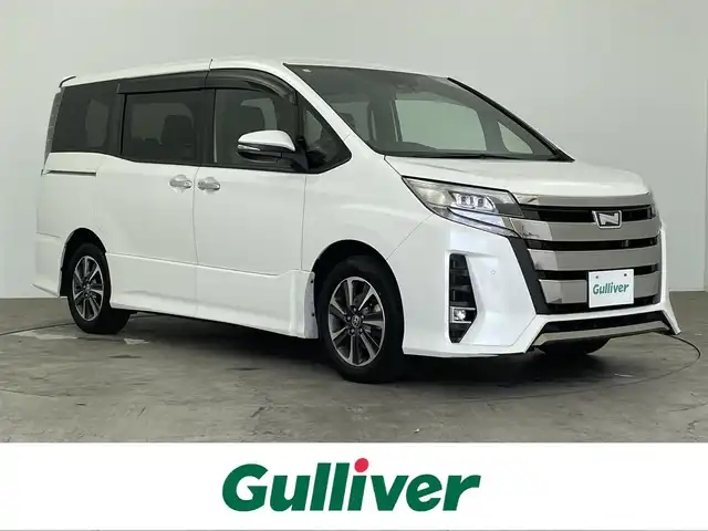 トヨタ ノア Si ダブルバイビーⅡ 大分県 2019(平31)年 7.6万km ホワイトパールクリスタルシャイン 純正9インチメモリナビ/(CD/DVD/BT/フルセグTV)/純正フリップダウンモニター/バックカメラ/両側パワースライドドア/ハーフレザーシート/スマートキー/プッシュスタート/ETC/電格ミラー/ウィンカーミラー/オートライト/フォグランプ/LEDヘッドライト/クルーズコントロール/クリアランスソナー/ドライブレコーダー/ステアリングスイッチ/革巻きステリング/純正16インチアルミホイール/ドアバイザー/フロアマット