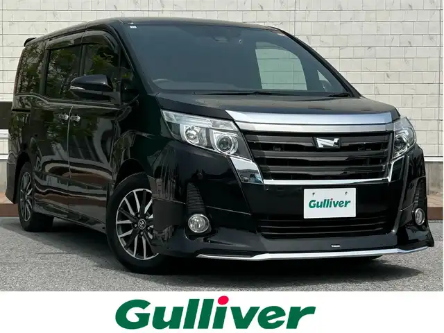 トヨタ ノア Si ダブルバイビー 滋賀県 2016(平28)年 6.1万km ブラック ガソリン/2WD(FF)/CVT/モデリスタエアロ/後席モニター/両側パワースライドドア/7インチ純正ナビ【NSZT-W62G】/(FM/AM/CD/DVD/フルセグ/Bluetooth)/ドライブレコーダー/ETC/バックカメラ/プリクラッシュブレーキアシスト	/レーンキープアシスト	/クルーズコントロール/コーナーセンサー/電動格納ミラー/アイドリングストップ/革巻きステアリング/ステアリングスイッチ/オートライト/LEDヘッドライト/フロントフォグ/オートマチックハイビーム/フルオートエアコン/プッシュスタート/スマートキー/スペアキー/純正フロアマット