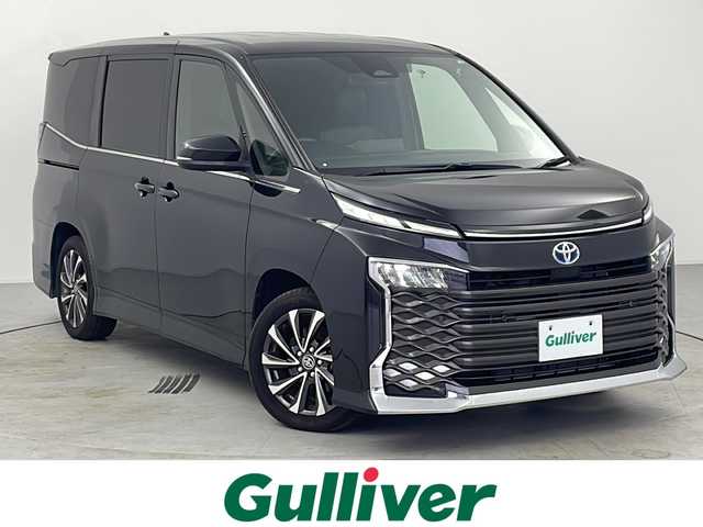 トヨタ ヴォクシー ハイブリッド S－Z 愛知県 2023(令5)年 3.2万km グリッターブラックガラスフレーク 純正10.5型ナビ/純正フリップダウンモニター/フルセグTV/バックカメラ/（BT/CD/DVD/HDMI)/プリクラッシュセーフティー/レーダークルーズコントロール/レーンディパーチャーアラート/クリアランスソナー/パーキングセンサー/ロードサインアシスト/横滑り防止装置/両側パワースライドドア/ビルトインETC/AC100V/リアサンシェード/LEDヘッドライト/オートライト/オートハイビーム