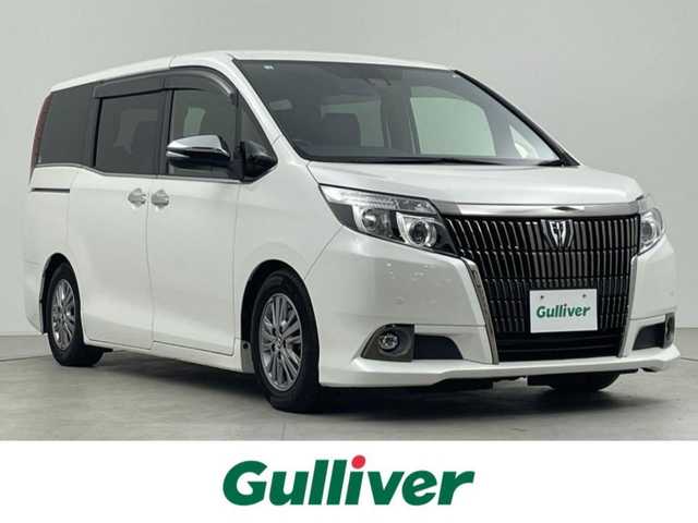 トヨタ エスクァイア Gi ブラックテーラード 千葉県 2016(平28)年 3.1万km ホワイトパールクリスタルシャイン 禁煙車/トヨタセーフティセンス/・レーンディパーチャーアラート/・先行車発進システム/・クルーズコントロール/・クリアランスソナー/両側電動ドア/純正9インチメモリナビ/・型番：NSZT-Y66T/・CD/DVD/Bluetooth/フルセグTV/・バックカメラ/・ビルトインETC/革巻きステアリング/・ステアリングスイッチ/MT付きAT/左右独立エアコン/合皮シート/・DNシートヒーター/純正フロアマット/純正ドアバイザー/純正15インチAW/オートライト/・LEDヘッドライト/・LEDフォグランプ/電動格納ウインカーミラー/アイドリングストップ/プッシュスタート/・スマートキー/・スペアキー