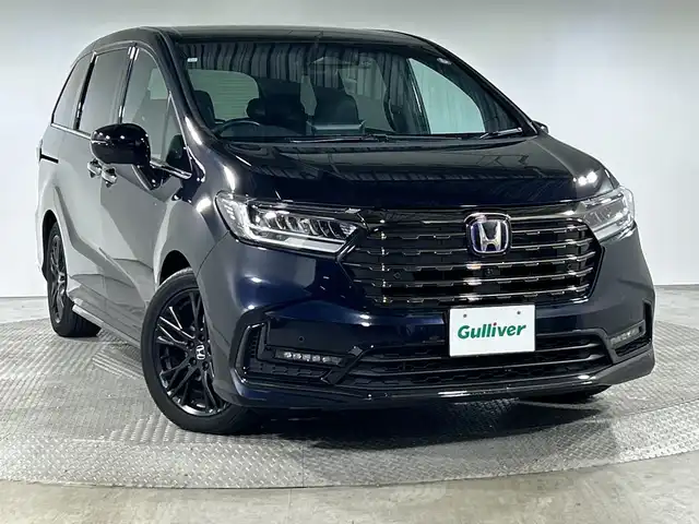 ホンダ オデッセイ ハイブリッド e:HEVアブソルート EXブラックED 神奈川県 2023(令5)年 3万km プレミアムヴィーナスブラックP 純正11.4型メモリーナビゲーション【LXM-247VFLi】/フルセグ　CD DVD　SD　USB　Bluetooth　HDMI　/マルチビューカメラ/両側電動スライドドア/パワーバックドア/ホンダセンシング/近距離衝突軽減ブレーキ/オートハイビーム/急アクセル抑制機能/衝突軽減ブレーキ/誤発進抑制機能/先行車発進お知らせ機能/アダブティブクルーズコントロール/レーンキープアシストシステム/LKAS車線維持支援システム/路外逸脱抑制機能/ブラインドスポットインフォメーション/踏み間違い衝突軽減システム/前後パーキングセンサー/革巻きステアリング/パドルシフト/本革シート/前席パワーシート/前席/後席左右シートヒーター/2列目電動オットマンシート/ECON/SPORT/ECO/EVモード/純正前後ドライブレコーダー/純正ビルトインETC/ワイヤレス充電/電動パーキングブレーキ/オートブレーキホールド/プッシュスタート/スマートキー/LEDヘッドランプ/LEDシーケンシャルターンランプ/オートライト/純正18インチアルミホイール