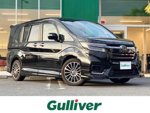 ホンダ ステップワゴン スパーダ ハイブリッドG EX HセンシングBスタイ 静岡県 2019(令1)年 5.8万km プレミアムスパークルブラックパール エンジンスタートボタン/パワーステアリング/パワーウィンドウ/100V充電/アイドリングストップ/スマートキー/Wオートエアコン/クルーズコントロール（追従有）/フリップダウンモニター/USB入力端子/ETC/バックカメラ/純正9インチメモリナビ（CD/BT/フルセグ）/三列シート/ウォークスルー/無限フロアマット/無限17インチアルミホイール/ハーフレザーシート/D席N席シートヒーター/両側パワースライドドア/フロント/サイドエアロ/ABS/横滑り防止装置/レーンキープアシスト/オートライト/LEDヘッドライト/W+サイドエアバック/カーテンエアバック/衝突軽減システム