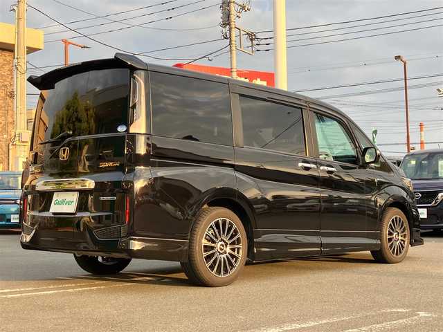 ホンダ ステップワゴン スパーダ ハイブリッドG EX HセンシングBスタイ 静岡県 2019(令1)年 5.8万km プレミアムスパークルブラックパール エンジンスタートボタン/パワーステアリング/パワーウィンドウ/100V充電/アイドリングストップ/スマートキー/Wオートエアコン/クルーズコントロール（追従有）/フリップダウンモニター/USB入力端子/ETC/バックカメラ/純正9インチメモリナビ（CD/BT/フルセグ）/三列シート/ウォークスルー/無限フロアマット/無限17インチアルミホイール/ハーフレザーシート/D席N席シートヒーター/両側パワースライドドア/フロント/サイドエアロ/ABS/横滑り防止装置/レーンキープアシスト/オートライト/LEDヘッドライト/W+サイドエアバック/カーテンエアバック/衝突軽減システム