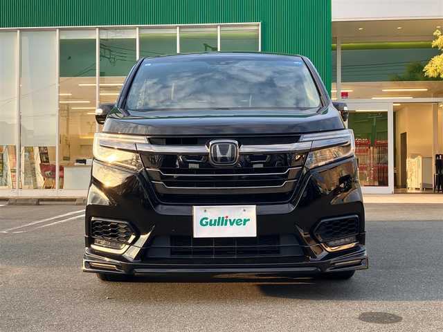 ホンダ ステップワゴン スパーダ ハイブリッドG EX HセンシングBスタイ 静岡県 2019(令1)年 5.8万km プレミアムスパークルブラックパール エンジンスタートボタン/パワーステアリング/パワーウィンドウ/100V充電/アイドリングストップ/スマートキー/Wオートエアコン/クルーズコントロール（追従有）/フリップダウンモニター/USB入力端子/ETC/バックカメラ/純正9インチメモリナビ（CD/BT/フルセグ）/三列シート/ウォークスルー/無限フロアマット/無限17インチアルミホイール/ハーフレザーシート/D席N席シートヒーター/両側パワースライドドア/フロント/サイドエアロ/ABS/横滑り防止装置/レーンキープアシスト/オートライト/LEDヘッドライト/W+サイドエアバック/カーテンエアバック/衝突軽減システム