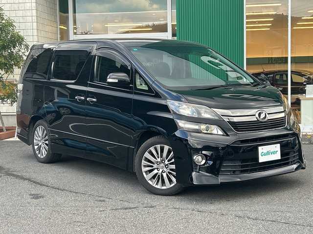 トヨタ ヴェルファイア 2．4Z ゴールデンアイズ 愛媛県 2013(平25)年 11万km ブラック アルパイン8インチナビ（VIE-X008)/・CD/DVD/フルセグTV/Bluetooth/10.2フリップダウンモニター/パワーバックドア/両側パワースライドドア/クルーズコントロール/ハーフレザーシート/2列目オットマンシート/コーナーセンサー/HIDオートライト/ウッドコンビハンドル/スマートキー2本/取扱説明書