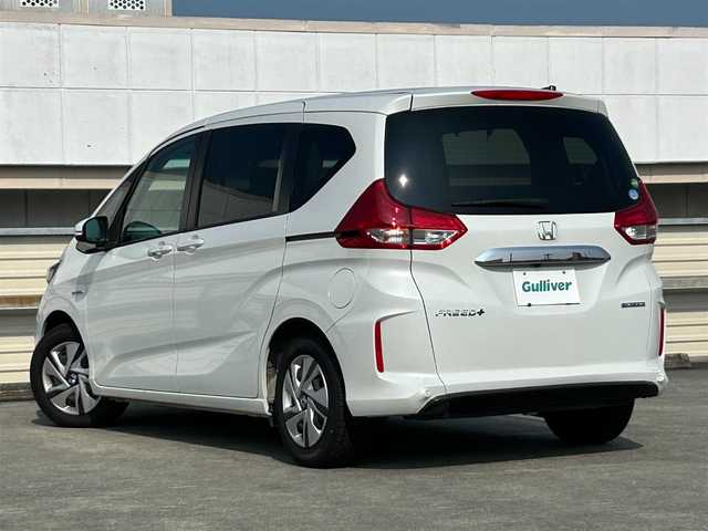 ホンダ フリード＋ ハイブリット G ホンダセンシング 静岡県 2021(令3)年 1.8万km プラチナホワイトパール ５人乗り/ホンダセンシング/Ｃパッケージ/純正９型ナビ/フルセグＴＶ/ＤＶＤ再生/ドラレコ/ＥＴＣ/両側電動スライドドア/シートヒーター/ＬＥＤヘッド/アクティブコーナリングライト/電格ミラー/ＡＣＣ