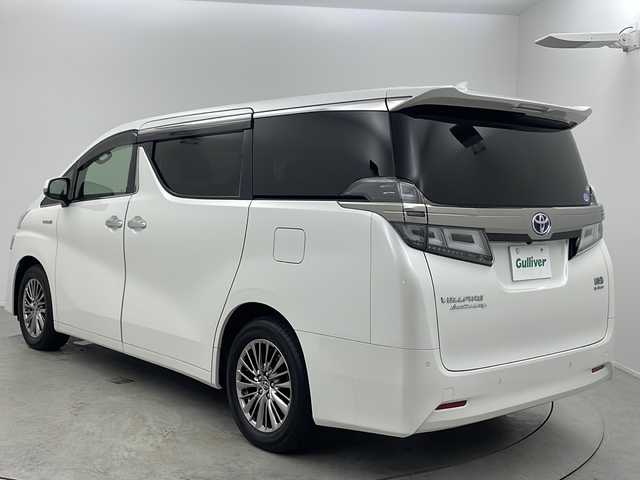 トヨタ ヴェルファイア ハイブリット エグゼクティブ ラウンジ 大阪府 2018(平30)年 1.5万km ホワイトパールクリスタルシャイン 純正９インチJBLナビ/【BT/フルセグTV/USB/AUX]/純正フリップダウンモニター/JBLスピーカー/ツインムーンルーフ/パノラミックビューモニター/デジタルインナーミラー/HDMI/ETC2.0/ドライブレコーダー前後/両側パワースライドドア/衝突被害軽減システム/ブラインドスポットモニター/コーナーセンサー前後/クルーズコントロール追従/パワーシート　D+N　二列目/シートヒーター/シートベンチレーション/オットマン/メモリシート/純正17インチアルミホイール/三眼LED