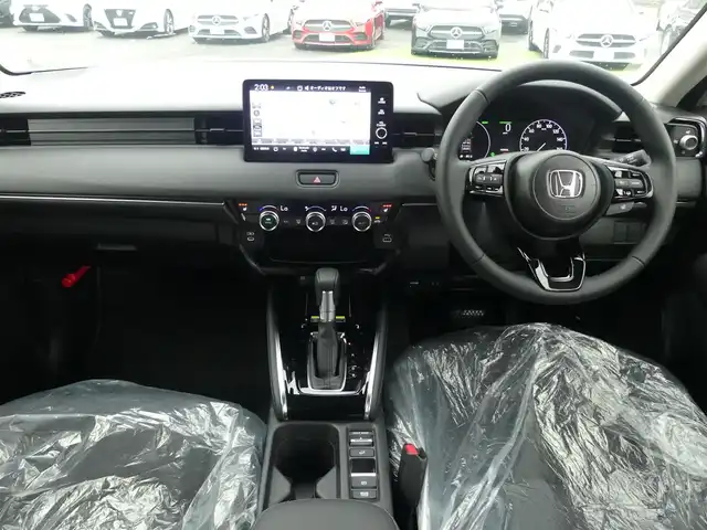 ホンダ ヴェゼル ハイブリッド e:HEV Z 千葉県 2025(令7)年 0.1千km プラチナホワイトパール e:HEV Z　4VC4AG3　Honda CONNECTディスプレー+ETC2.0車載器+ワイヤレス充電器(231000)/ホンダセンシング/・アダプティブクルーズコントロール（ACC）/・車線維持支援システム（LKAS）/・アダプティブクルーズコントロール（ACC）/・後方誤発進抑制機能/・誤発進抑制機能/パワーバックドア/ハーフレザーシート/前席シートヒーター/ホンダコネクトナビ/地デジTV/【Bluetooth接続】/【Apple CarPlay　Android Auto対応】/バックカメラ/ワイヤレス充電/革巻きステアリング/ステアリングスイッチ/ステアリングヒーター/パドルシフト/ETC（2.0）/LEDヘッドライト/フォグライト/ウインカーミラー/コーナーセンサー/純正18インチアルミホイル/サイド/カーテンエアバッグ/Honda スマートキー