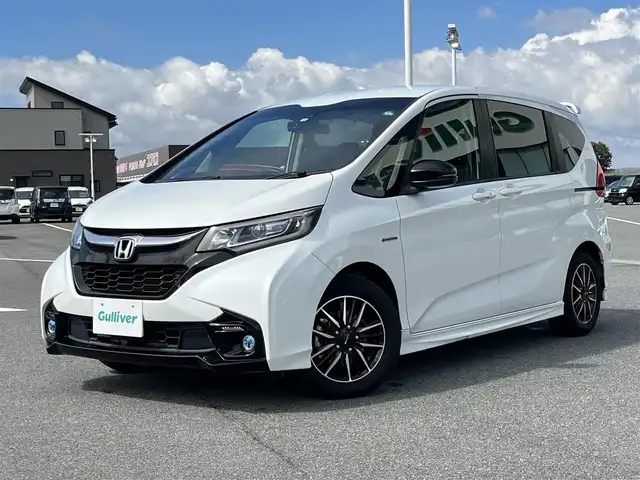 ホンダ フリード ハイブリット モデューロX ホンダセンシング 奈良県 2018(平30)年 5.4万km ホワイトオーキッドパール 純正ナビ（VXM-185VFi)/（TV/BT/CD/DVD）/純正フリップダウンモニター/レーダークルーズコントロール/バックカメラ/衝突軽減システム/レーンキープアシスト/両側パワースライドドア/ハーフレザーシート/後席サンシェード/前方ドライブレコーダー/ETC/純正15インチAW