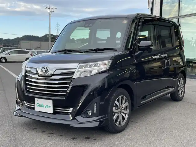 トヨタ ルーミー カスタムG－T 愛媛県 2020(令2)年 3.8万km ブラックマイカメタリック 純正9型ナビ(フルセグTV/BT)/両側パワースライドドア/バックカメラ/スマートアシスト/クルーズコントロール/クリアランスソナー/衝突被害軽減装置/車線逸脱防止装置/LEＤヘッドライト/オートライト/ドライブレコーダー/ETC2.0/後席サンシェイド/電格ミラー/ステアリングリモコン/シガーソケット/純正ドアバイザー/現状サマー(純正AW)(175/65/R15)/GOODYEAR EfficientGrip ECO EG02/禁煙車