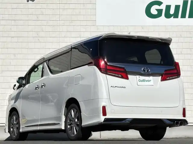 トヨタ アルファード S タイプゴールドⅡ 岩手県 2021(令3)年 7.4万km ホワイトパールクリスタルシャイン 禁煙車/4WD/モデリスタフルエアロ/モデリスタマフラー/純正ディスプレイオーディオ（ナビ機能付）/→Bluetooth/DVD/FM/AM/純正後席用フリップダウンモニター/バックカメラ/両側パワースライドドア/パワーバックドア/ハーフレザー/トヨタセーフティセンス/追従型クルーズコントロール/レーンキープアシスト/衝突軽減システム/横滑り防止装置/電子パーキング/オートブレーキホールド/オートライト/オートハイビーム/LEDヘッドライト/LEDフォグライト/純正エンジンスターター/ステアリングスイッチ/プッシュスタート/社外フロアマット/シガーソケット/スマートキー/ビルトインETC/オットマン