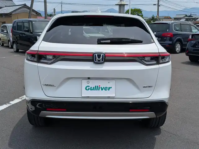 ホンダ ヴェゼル ハイブリッド e:HEV Z 福井県 2021(令3)年 6.1万km プラチナホワイトパール ワンオーナー車/純正18インチAW/バックカメラ/全方位ドライブレコーダー/ワイヤレス充電/パドルシフト/ステアリングヒーター/SOSボタン/電動リアゲート/アダプティブクルーズコントロール/前後コーナーセンサー/クリアランスソナー/純正9インチプレミアムインターナビ/フルセグテレビ/ETC/衝突被害軽減システム/前席シートヒーター/レーンキープアシスト/横滑り防止装置/盗難防止装置/スマートキー