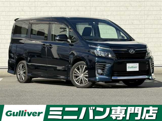 トヨタ ヴォクシー ZS 福岡県 2014(平26)年 4.8万km ブラッキッシュアゲハガラスフレーク 禁煙車純正９型SDナビ（フルセグTV/DVD/CD/BT）バックモニター両側パワスラフリップダウンモニターアイドリングストップドラレコETCLEDヘッドライトスマートキー×２社外１７インチAW