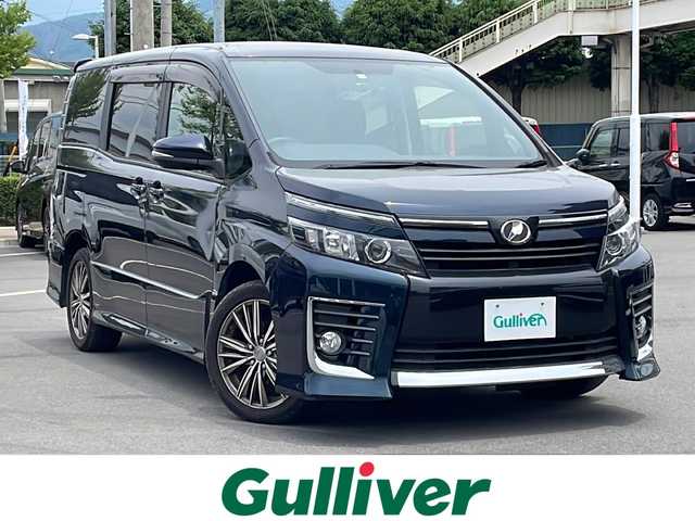 トヨタ ヴォクシー ZS 長野県 2014(平26)年 4.7万km ブラッキッシュアゲハガラスフレーク 純正９型SDナビ/・フルセグTV/・CD/DVD/・Bluetooth/バックモニター/純正フロアマット/両側パワスラ/フリップダウンモニター/ドラレコ/ETC/LEDヘッドライト/スペアキー1本/社外１７インチAW/オートエアコン/ステアリングスイッチ/アイドリングストップ/プッシュスタート/オートライト/ABS