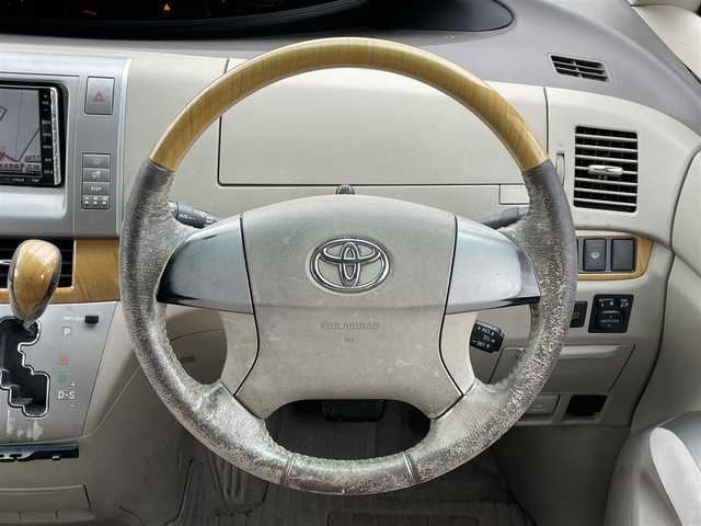 トヨタ エスティマ G 道央・札幌 2006(平18)年 17.6万km ホワイトパールクリスタルシャイン ４WD/寒冷地仕様/純正ディーラーOPナビ/CD/DVD/SD/フルセグ/純正フリップダウンモニター/クルーズコントロール/バックカメラ/ビルトインETC/センターデフロック/AFS/両側パワースライドドア/パワーバックドア/D席パワーシート/電動格納サードシート/2列目オットマン/レザー調シートカバー/革巻きウッドコンビステアリング/MTモード付AT/プッシュスタート/スマートキー/ハロゲンヘッドライト/オートライト/フォグランプ/電動格納ミラー/ウィンカーミラー/純正フロアマット/ドアバイザー/スペアキー/社外エンジンスターター