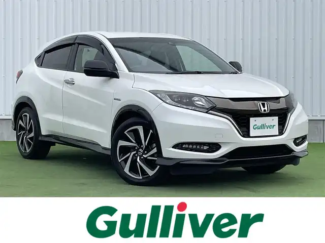 ホンダ ヴェゼル ハイブリッド RS ホンダセンシング 香川県 2016(平28)年 5.2万km ホワイトオーキッドパール ディーラーオプション8インチインターナビ/→フルセグ/CD/DVD/Bluetooth/→iPod/AUX/HDMI/バックカメラ/Honda SENSING/・ACC(アダプティブクルーズコントロール)/・CMBS（衝突被害軽減ブレーキ）/・LKAS（車線維持支援システム）/・路外逸脱抑制機能/・誤発進抑制機能/・先行車発進お知らせ機能/・標識認識機能/・歩行者事故低減ステアリング/・オートハイビーム/LEDヘッドライト/ハーフレザーシート/前席シートヒーター/革巻きステアリング/ステアリングリモコン/電子パーキングブレーキ/オートブレーキホールド/純正18インチアルミ/ETC/前方ドライブレコーダー